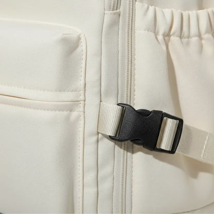 Close-up of a white jacket with a black zipper and buckle on a computer screen.