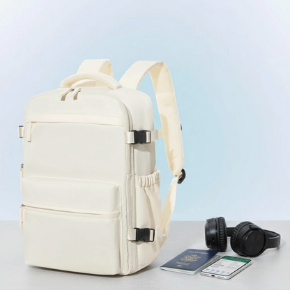 Beige backpack with a passport, phone, and headphones on a light blue background